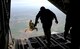U.S. Air Force Air Commandos from the 321st Special Tactics Squadron perform a military free fall from an MC-130J Commando II March 17, 2017, over RAF Mildenhall, England. Air Commandos practice military free falls to stay prepared and highly trained for real-world situations that require the tactical maneuver. Friends and family of the Airmen were in attendance at the drop zone to support their air commandos. (U.S. Air Force photo by Staff Sgt. Kate Thornton)