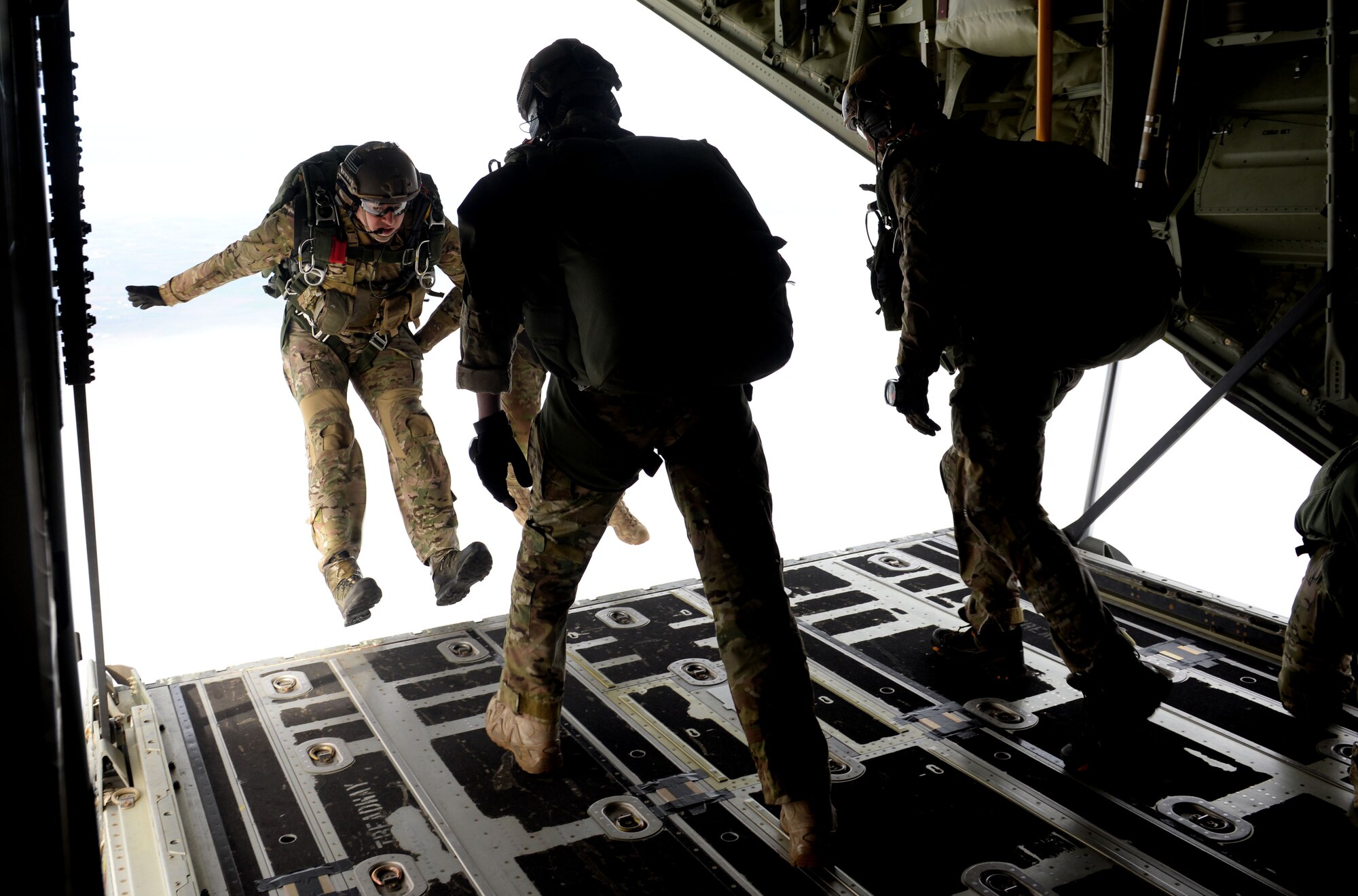 U.S. Air Force Air Commandos from the 321st Special Tactics Squadron perform a military free fall from an MC-130J Commando II March 17, 2017, over RAF Mildenhall, England. Air Commandos practice military free falls to stay prepared and highly trained for real-world situations that require the tactical maneuver. Friends and family of the Airmen were in attendance at the drop zone to support their Air Commandos. (U.S. Air Force photo by Staff Sgt. Kate Thornton)