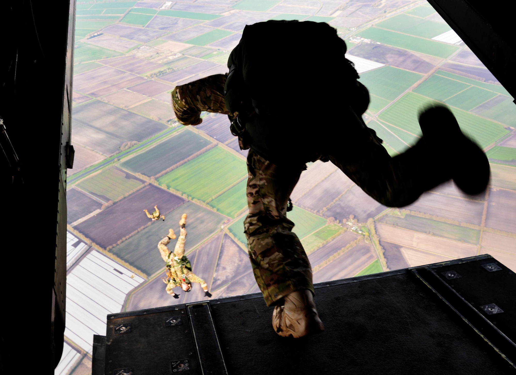 U.S. Air Force Air Commandos assigned to the 321st Special Tactics Squadron execute a military free fall from a CV-22 Osprey, March 17, 2017, over RAF Mildenhall, England. The exercise also included Air Commandos performing free falls from an MC-130J Commando II and allows flight crew and 321st STS members to practice safely deploying from aircraft to reach designated drop zones. (U.S. Air Force photo by Senior Airman Justine Rho)