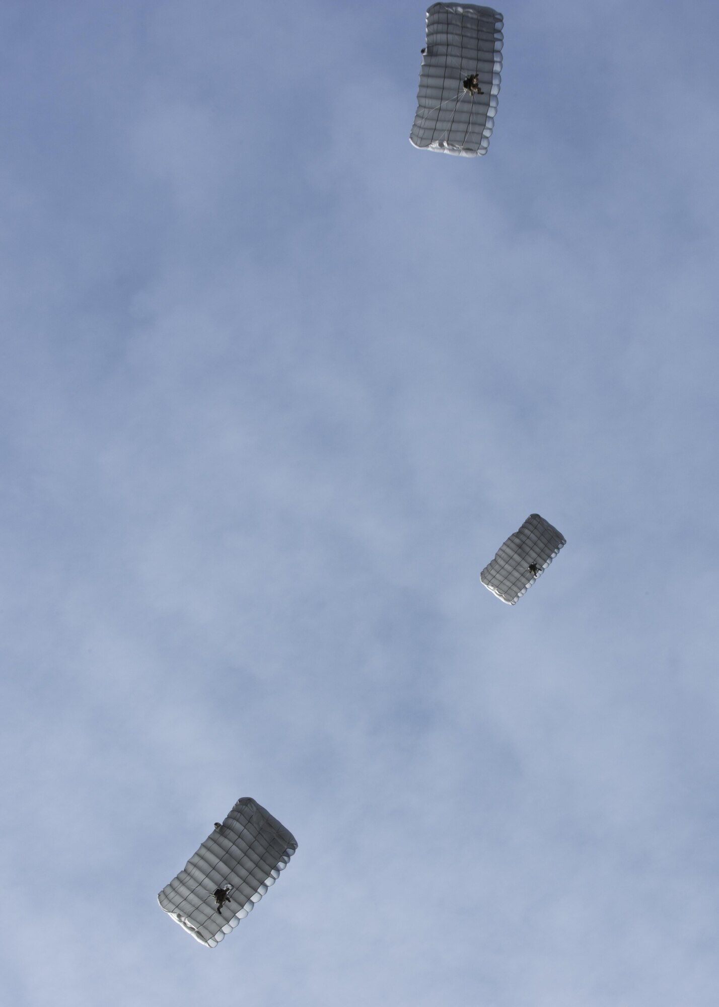 U.S. Air Force Air Commandos from the 321st Special Tactics Squadron parachute to the ground after performing a military free fall from CV-22 Osprey and MC130J Commando II aircraft March 17, 2017, over RAF Mildenhall, England. The exercise allowed flight crew and 321st STS Air Commandos to practice safely deploying from aircraft to reach designated drop zones safely. (U.S. Air Force photo by Capt Chris Sullivan)