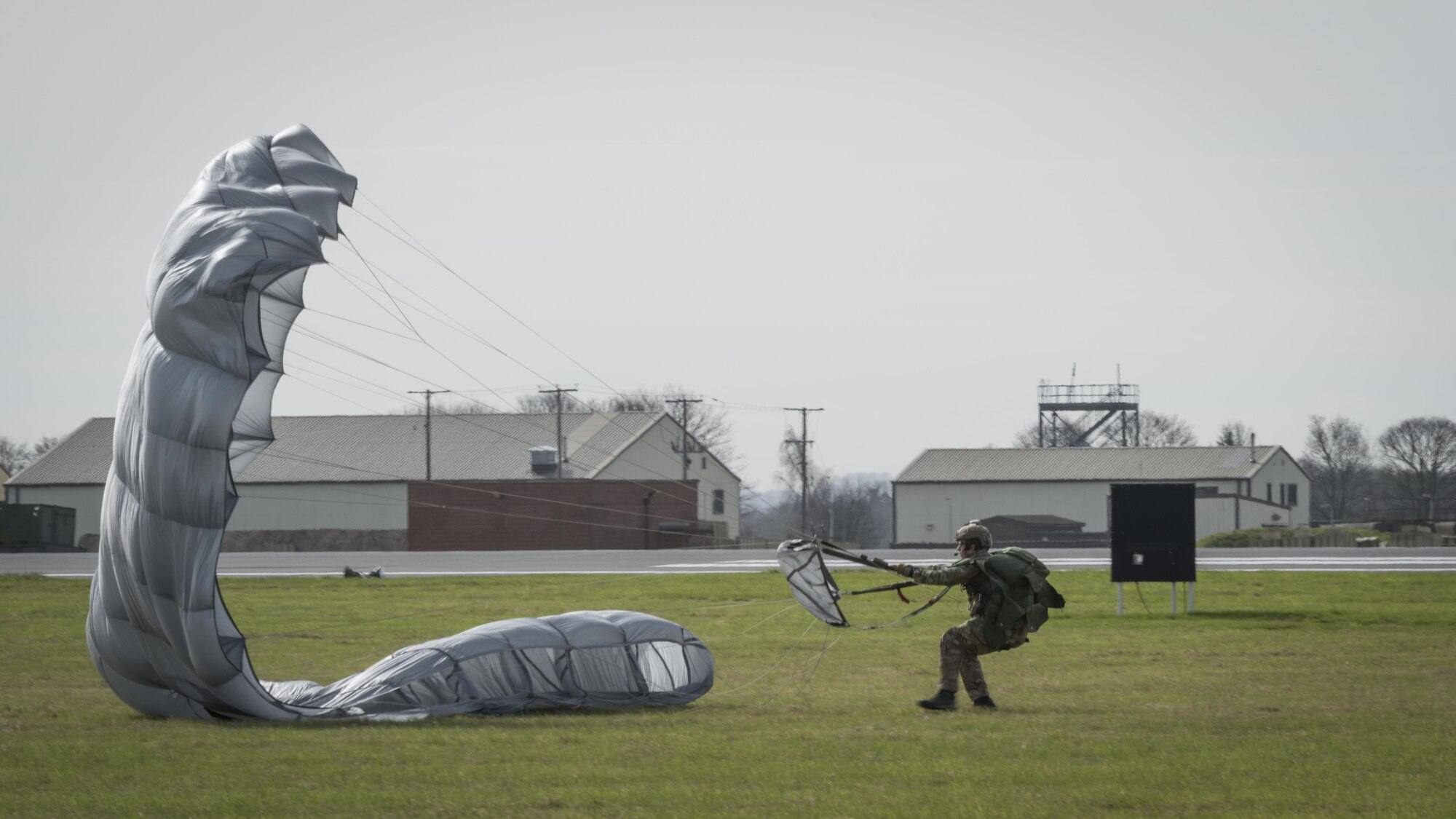 A U.S. Air Force Air Commando from the 321st Special Tactics Squadron recovers his parachute after performing a military free fall from an MC-130J Commando II March 17, 2017, over RAF Mildenhall, England. Airmen from the 352d Special Operations Wing exercised the procedure from MC-130J and CV-22 Osprey aircraft to allow aircrews and special tactics airmen the opportunity to practice the procedure in a controlled environment. (U.S. Air Force photo by Capt Chris Sullivan)