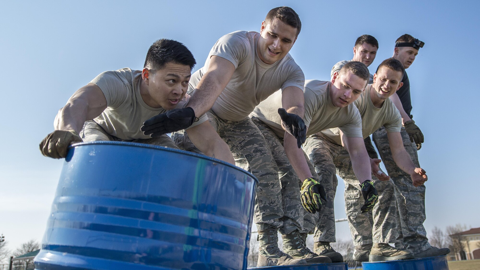 Airmen from the 31st Civil Engineer Squadron participate in the first Combat Warrior Challenge at Aviano Air Base, March 14, 2017. Among several obstacles, one saw each team move four barrels 20 yards without participants touching the ground. (U.S. Air Force photo by Senior Airman Cory W. Bush)