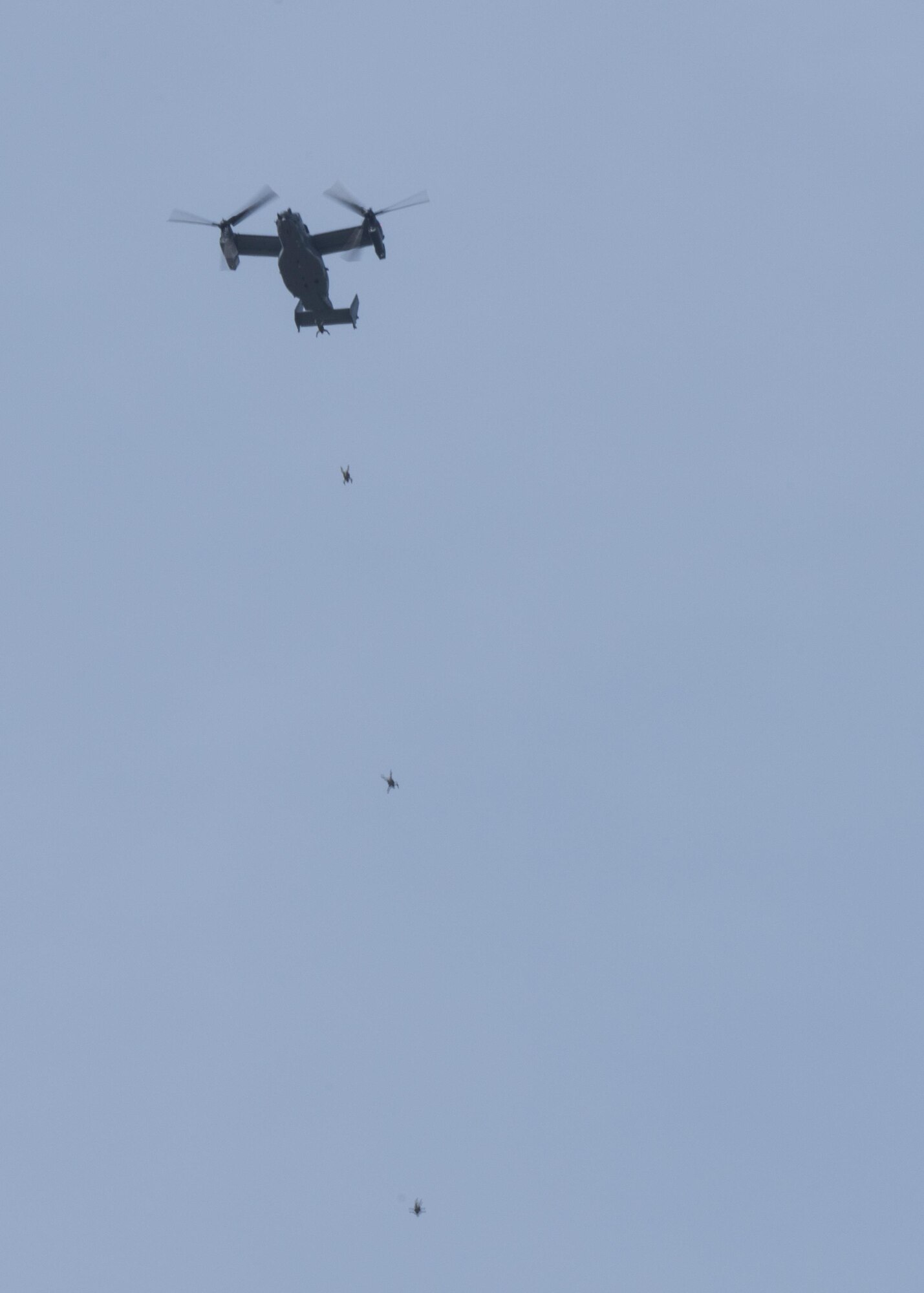 U.S. Air Force Air Commandos from the 321st Special Tactics Squadron perform a military free fall from a CV-22 Osprey March 17, 2017, over RAF Mildenhall, England. Military free fall is an alternative method of insertion Special Operations Forces use when landing a military aircraft is impractical due to rough terrain or hostile territory. (U.S. Air Force photo by Staff Capt Chris Sullivan)