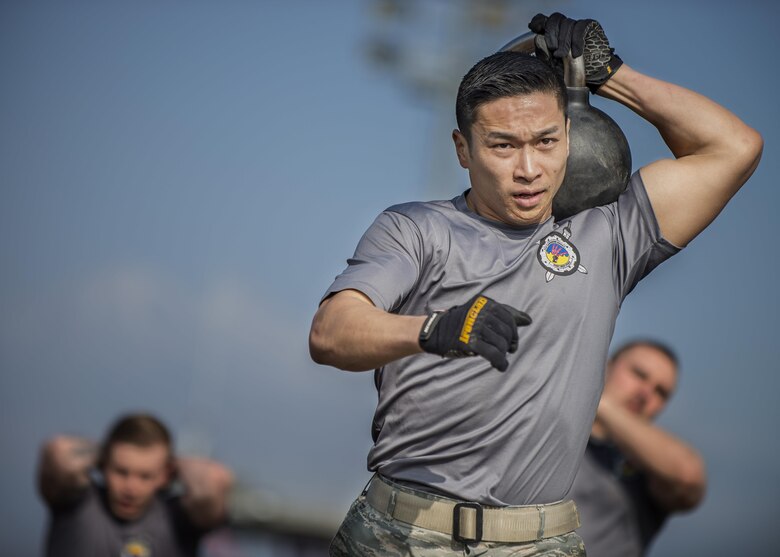 Staff Sgt. Ly Wong, 31st Communications Squadron, participates in the first Combat Warrior Challenge at Aviano Air Base, March 17, 2017. Among several obstacles, one required teams to carry six kettlebells 100 yards. (U.S. Air Force photo by Senior Airman Cory W. Bush)
