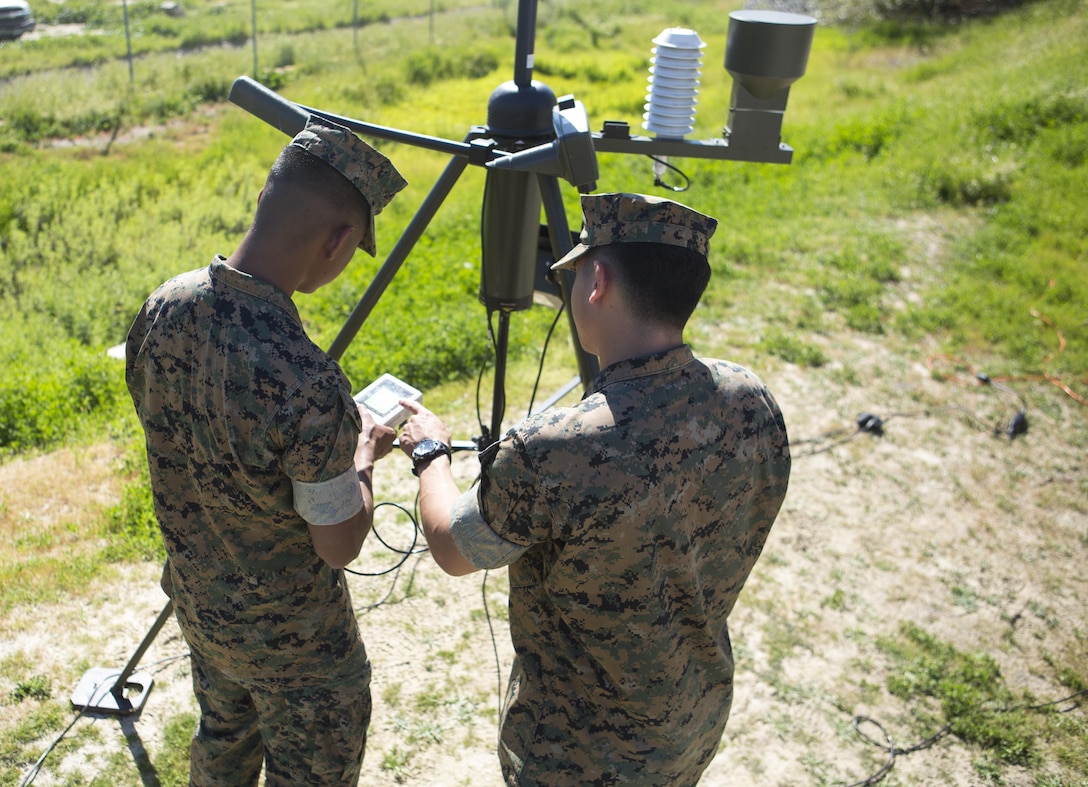Lance Cpl. Christopher Ruaboro (left) and Cpl. Timothy Brooks, meteorological and oceanographic (METOC) forecasters with Battle Space and Surveillance Company, 1st Intelligence Battalion, I Marine Expeditionary Force, use the automated weather operating system to record weather observations for their weekly, 24-hour METOC observer certification exercise at Marine Corps Base Camp Pendleton, Mar 14, 2017. The weather forecasts provided by the METOC Marines assist commanders in air, sea or ground operations. Brooks is a native of Rockville, Maryland, and Ruaboro is a native of Lihue, Hawaii. (U.S. Marine Corps photo by Lance Cpl. Justin Bowles)
