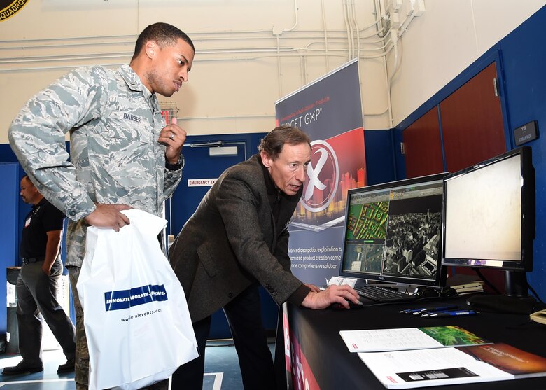 SCHRIEVER AIR FORCE BASE, Colo. -- 2nd Lt. Kenneth Barber, 3rd Space Experimentation Squadron GPS crew chief, receives a real-time demonstration on intelligence and security solutions from Rick Racine, BAE Systems business developer during the 2017 Tech Expo, at Schriever Air Force Base, Colorado, and Tuesday, March 21. The expo featured nearly 30 vendors and 200 attendees. The technology on display ranged from fiber optic cables for various applications, to network and communication solutions. (U.S. Air Force photo/ Staff Sgt. Matthew Coleman-Foster)