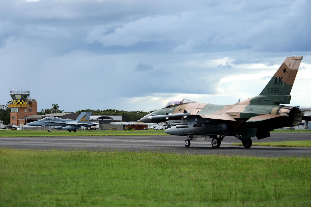 A U.S. Air Force F-16 Fighting Falcon and a Royal Australian Air Force F-18A Hornet taxi at Royal Australian Air Force Base Williamtown in New South Wales, Australia, during exercise Diamond Shield 2017, March 21, 2017. Air Force photo by Tech. Sgt. Steven R. Doty