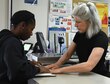Sharon McCrea, Malmstrom Air Force Base postmaster, right, helps 2nd Lt. Eboni Simpson, 12th Missile Squadron missileer, tape down a package prior to mailing it off at the base contract postal unit March 21, 2017, at Malmstrom Air Force Base, Mont. Daily, the base post office sends out approximately 300 pounds of mail to different locations. (U.S. Air Force photo/Senior Airman Jaeda Tookes)