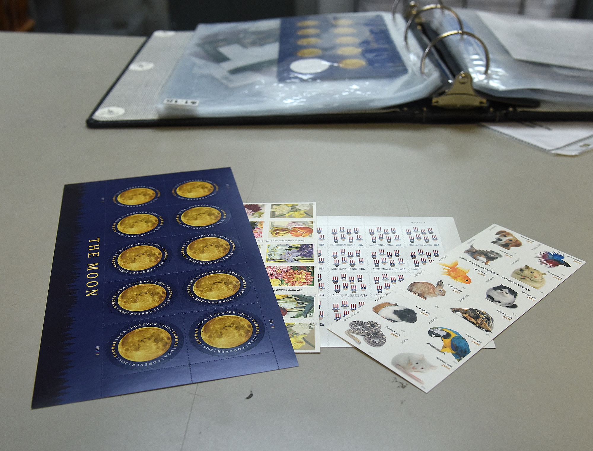 A variety of stamps are pictured on the counter at the base contract postal unit March 21, 2017, at Malmstrom Air Force Base, Mont. The base post office opened last year for military members and their families. (U.S. Air Force photo/Senior Airman Jaeda Tookes)