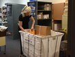 Sharon McCrea, Malmstrom Air Force Base postmaster, places mail inside a mail cart at the base contract postal unit March 21, 2017, at Malmstrom Air Force Base, Mont. All mail processed in before collection time is sent out the same night. (U.S. Air Force photo/Senior Airman Jaeda Tookes)