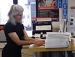 Sharon McCrea, Malmstrom Air Force Base postmaster, straightens address labels for customers at the base contract postal unit March 21, 2017, at Malmstom Air Force Base, Mont. McCrea is a one-person shop, but hopes to eventually expand her team once she grasps the aspects of what people need. (U.S. Air Force photo/Senior Airman Jaeda Tookes)
