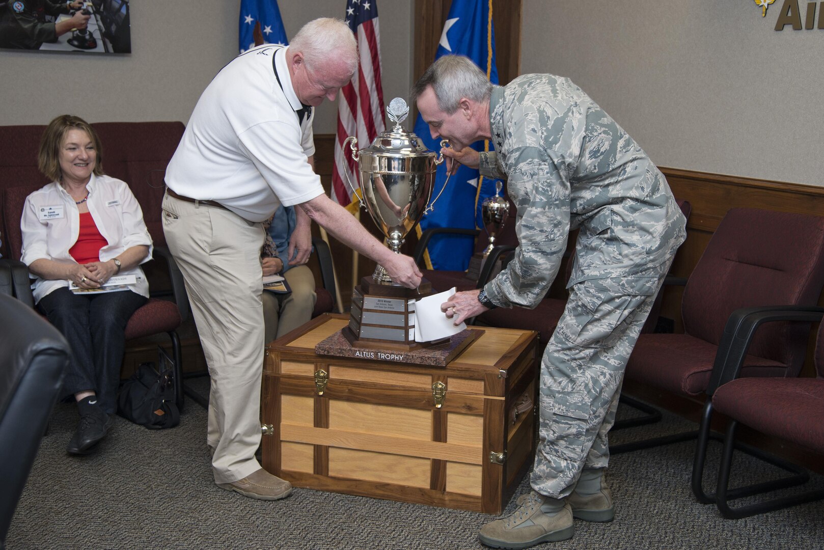 Lt. Gen. Darryl Roberson, commander of Air Education and Training Command, and Dr. Joe Leverett (left), Altus Trophy selection committee chairman, unveil the name of the winner of the 2016 Altus Trophy March 22, 2017, at Joint Base San Antonio-Randolph, Texas. The Altus Trophy is given annually to a community judged to have shown outstanding support to an AETC base. (U.S. Air Force photo by Sean Worrell)