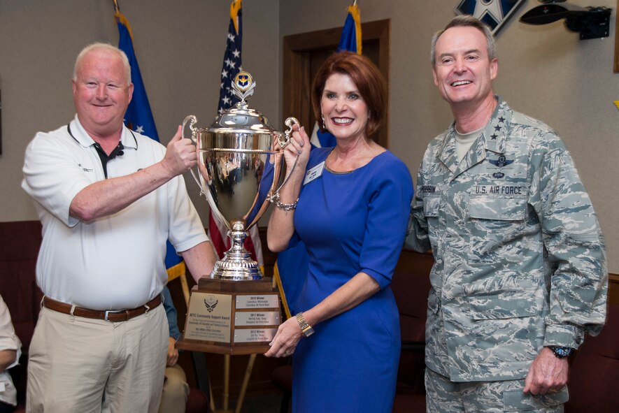 Lt. Gen. Darryl Roberson, commander of Air Education and Training Command, and Dr. Joe Leverett (left), Altus Trophy selection committee chairman, present the 2016 Altus Trophy to Diane Rath (center), Alamo Area Council of Governments executive director, March 22, 2017, at Joint Base San Antonio-Randolph, Texas. The Altus Trophy is given annually to a community judged to have shown outstanding support to an AETC base. (U.S. Air Force photo by Sean Worrell)