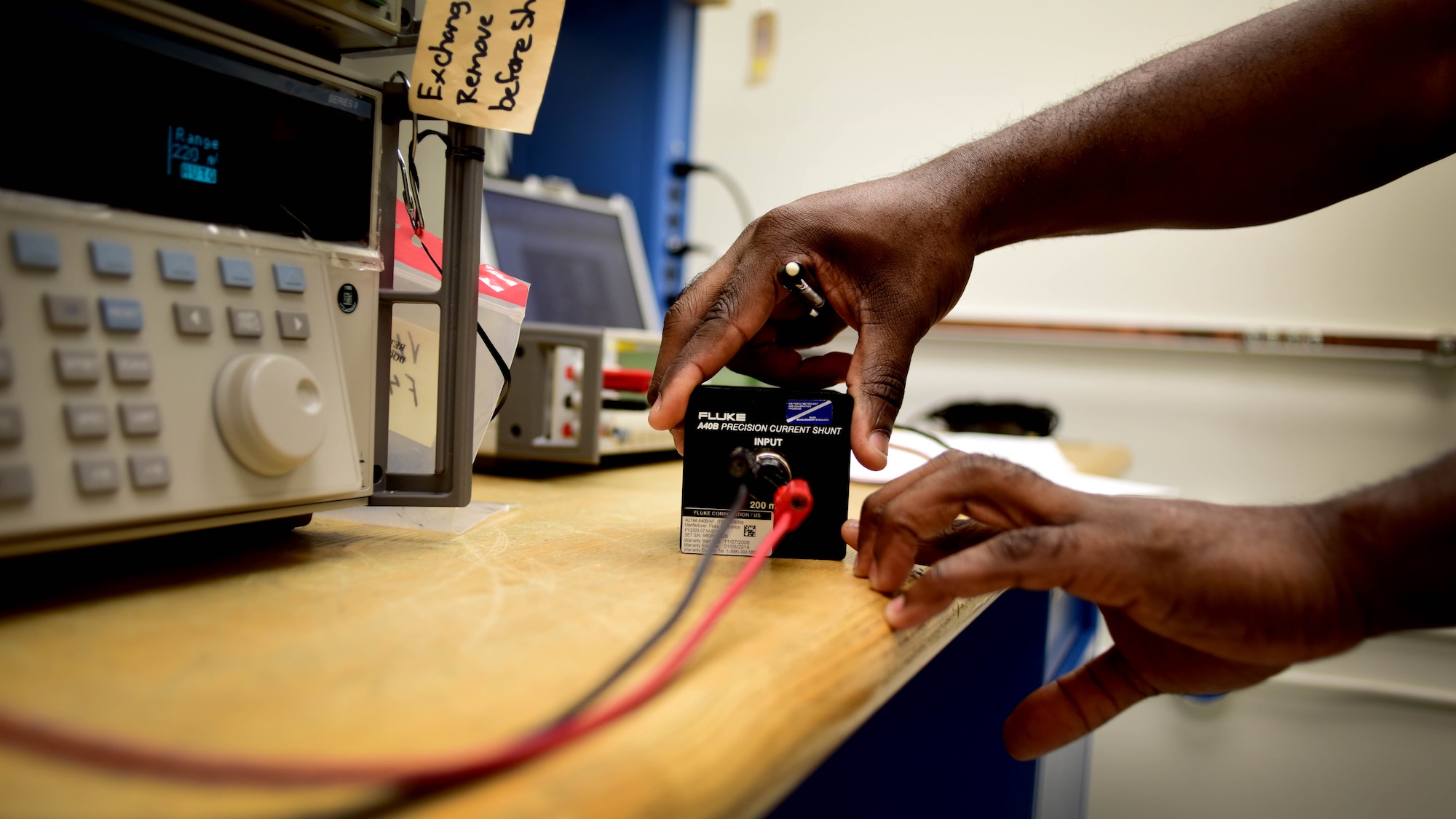Ernest Triplett, 1st Maintenance Squadron precision measurement equipment laboratory electronics technician, calibrates a 5720A Multifunction Calibrator using current shunts at Joint Base Langley-Eustis, Va., March 20, 2017. The PMEL flight has two sections, electrical standards and physical dimensions, that work together to calibrate equipment across numerous spectrums to include voltage, resistance, current, frequency, power, temperature, linear, force, tension and pressure. (U.S. Air Force photo/Senior Airman Areca T. Bell)