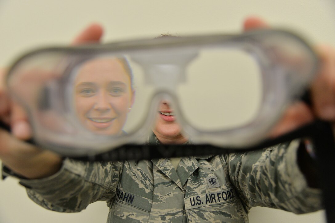 Staff Sgt. Allison Hahn, 341st Medical Operations Squadron NCO in charge of mental health, holds goggles that simulate being under the influence of alcohol March 21, 2017, at Malmstrom Air Force Base, Mont. In addition to mental health, the Alcohol and Drug Abuse Prevention and Treatment program and Family Advocacy Program are also services part of mental health that are available to Airmen and their dependents. (U.S. Air Force photo/Airman 1st Class Daniel Brosam)