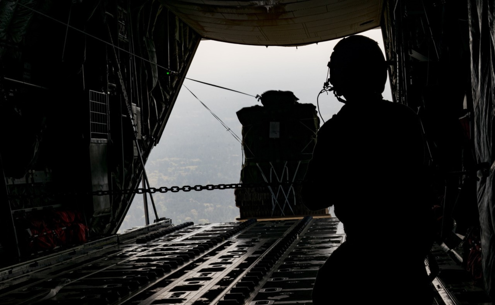 Tech. Sgt. Jonathan Packer, 815th Airlift Squadron, drops a package from a C-130J Super Hercules aircraft during the Green Flag Little Rock 17-05 exercise March 19 in Alexandria, Louisiana. The exercise provided training in a deployment simulation. (U.S. Air Force photo/Staff Sgt. Shelton Sherrill)
