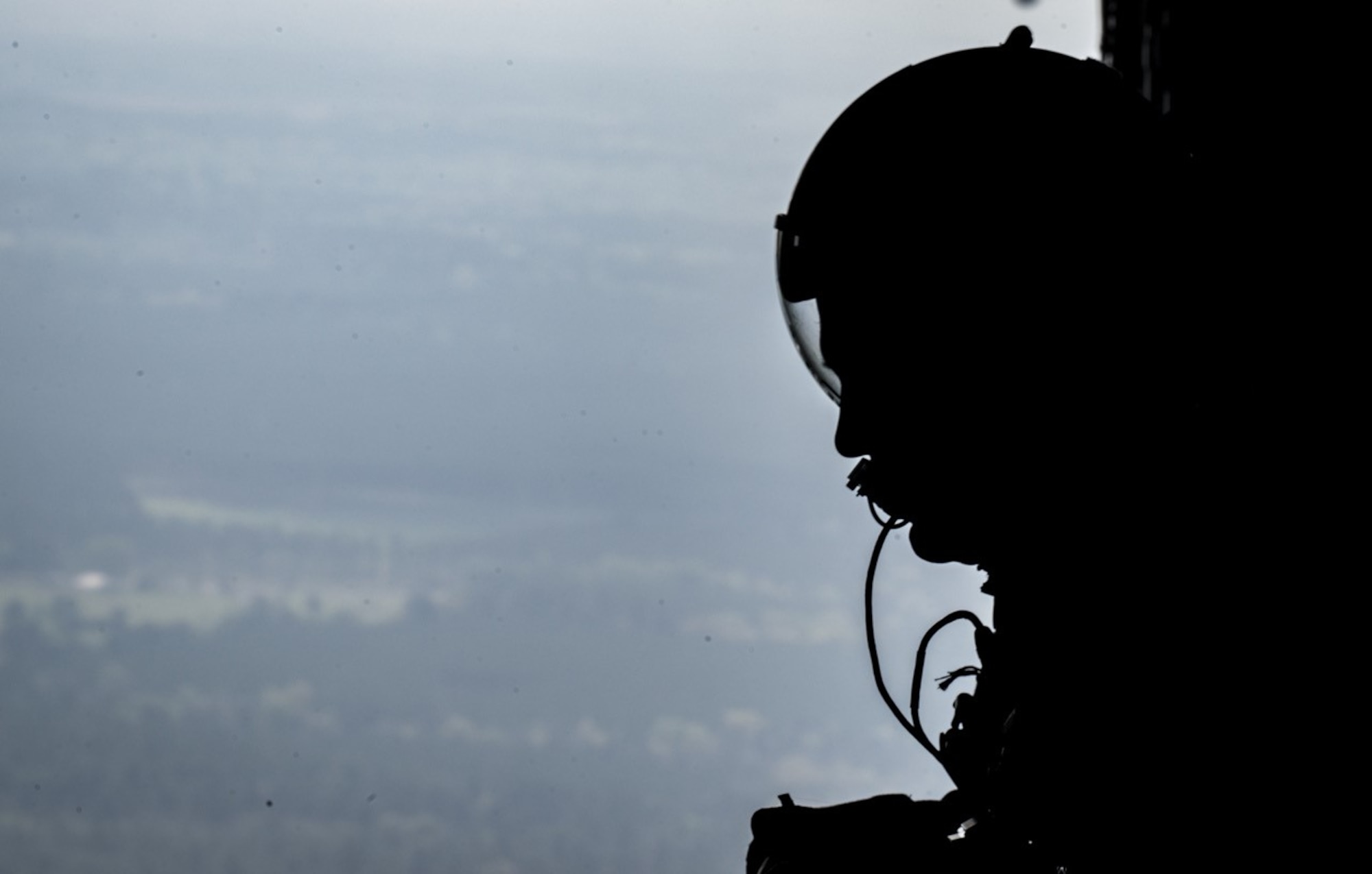 Tech. Sgt. Jonathan Packer, 815th Airlift Squadron,  looks out of a C-130J Super Hercules aircraft after doing an air drop March 19  in Alexandria, Louisiana. The airdrop was part of a mission during the Green Flag Little Rock 17-05 exercise. (U.S. Air Force photo/Staff Sgt. Shelton Sherrill)