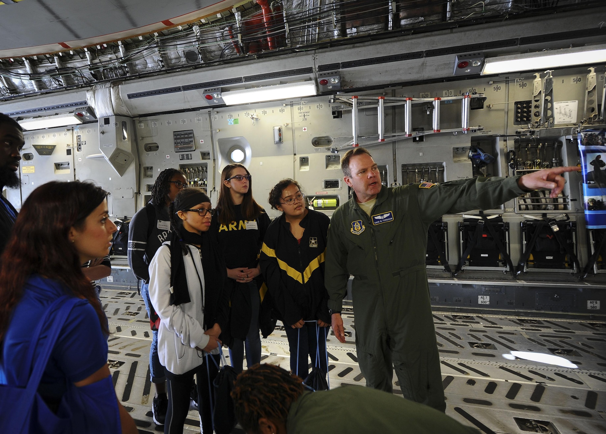 Lt. Col. David Ferguson, 315th Aeromedical Evacuation Squadron flight nurse, explains how the aeromedical evacuation process works on a C-17 Globemaster III at the 10th Annual Joint Base Charleston Women in Aviation Career Day March 20 at Joint Base Charleston, S.C. (U.S. Air Force Photo by Senior Airman Tom Brading)