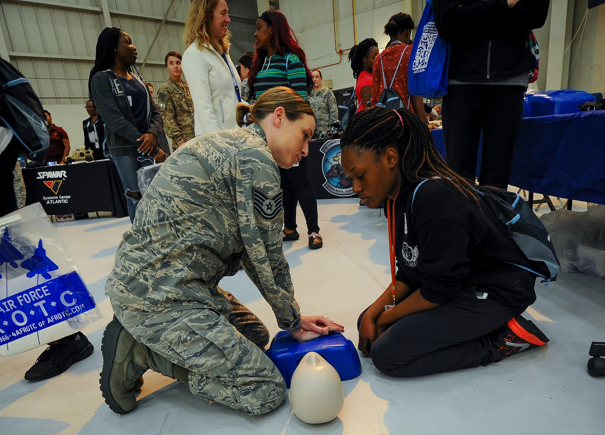 Tech Sgt. Melanie Frederick, 315th Aerospace Medicine Squadron, shows a local student how basic CPR check compressions are done at the 10th Annual Joint Base Charleston Women in Aviation Career Day March 20 at Joint Base Charleston, S.C.