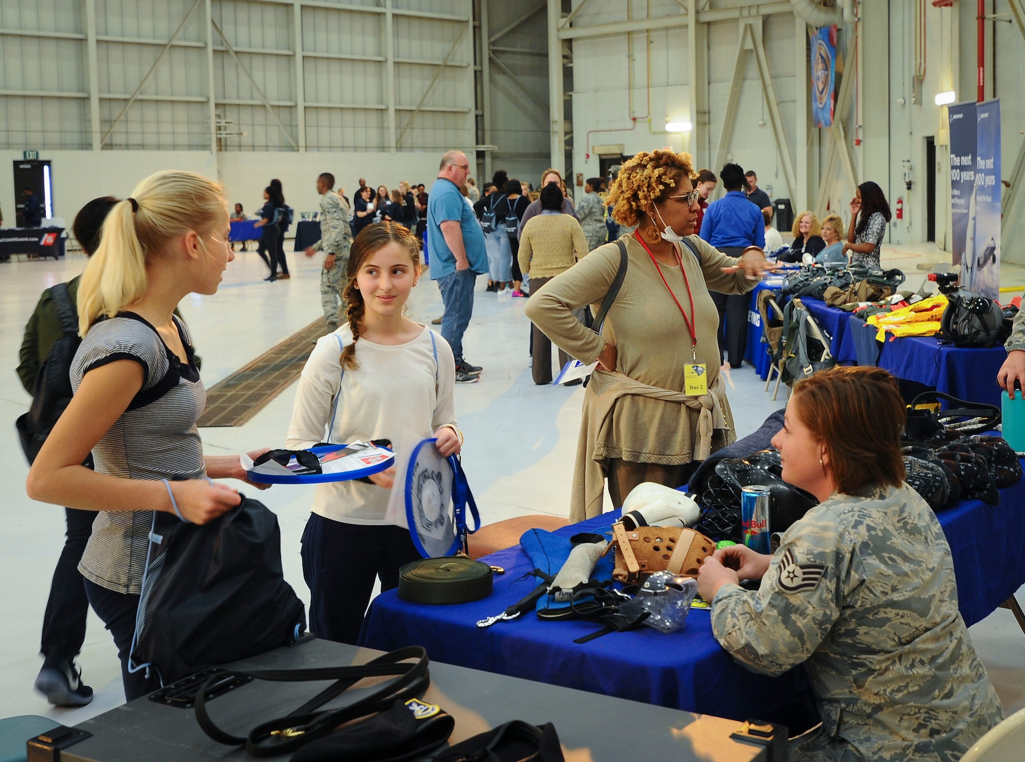 Staff Sgt. Angela Loew, 628th Security Force Squadron military working dog handler, speaks to girls at the 10th Annual Joint Base Charleston Women in Aviation Career Day March 20 at Joint Base Charleston, S.C. (U.S. Air Force Photo by Senior Airman Tom Brading)