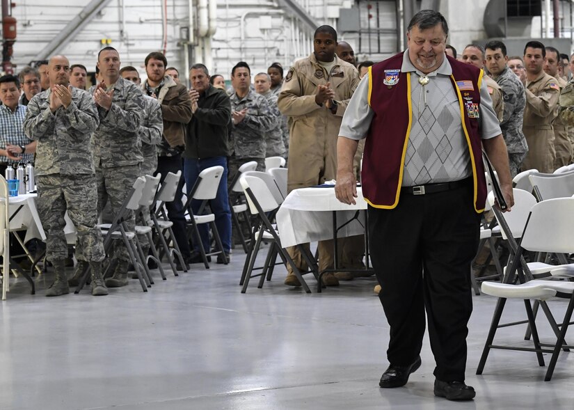 Members of the 437th Maintenance Group cheer as retired U.S. Air Force Capt. William Robinson, longest surviving enlisted prisoner of war, makes his way to the stage during an award ceremony here, March 17, 2017. Robinson was a POW for nearly eight years before being released. Now, Robinson speaks about his experience with community and military members across the country.
