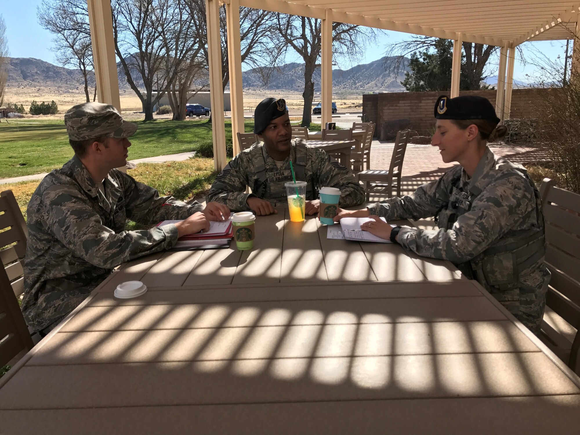 1st Lt. Corey Fox, Master Sgt. Darryl Lyles and 2nd Lt. Brittany Oxley discuss Air Force Assistance Fund campaign preparations at the Tijeras Arroyo Golf Course.  The campaign kicks off March 28 with a burger burn at Marquez Park. 