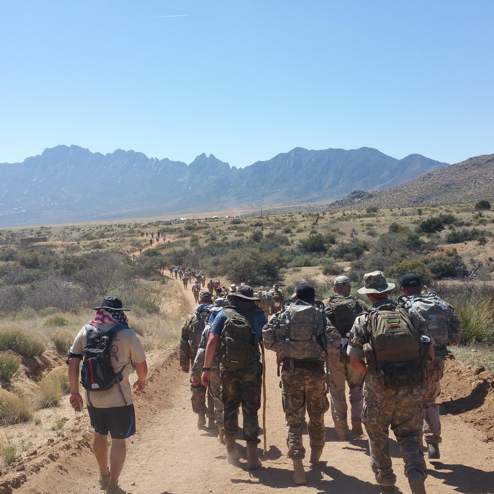 Participants in the Bataan Memorial Death March trek through the desert of White Sands Missile Range, New Mexico, March 19, 2017. The Bataan Memorial Death March commemorates the infamous 65-mile forced march of more than 60,000 American and Filipino troops during World War II.  (U.S. Air National Guard photo by Tech. Sgt. Michael Matkin)