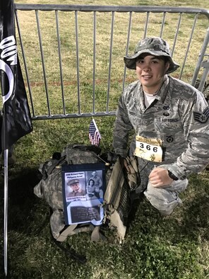 U.S. Air Force Staff Sgt. Max Biser, 23d Security Forces Squadron NCO in charge of confinement, poses next to his rucksack during the Bataan Memorial Death March, March 19, 2017, at White Sands Missile Range, N.M. Biser marched 26.2 miles to honor his grandfather, retired U.S. Army Sgt. Maj. Ricardo Plana. Plana and thousands more prisoners of war were forced to march 70 miles before entering concentration camps during WWII. (courtesy photo)