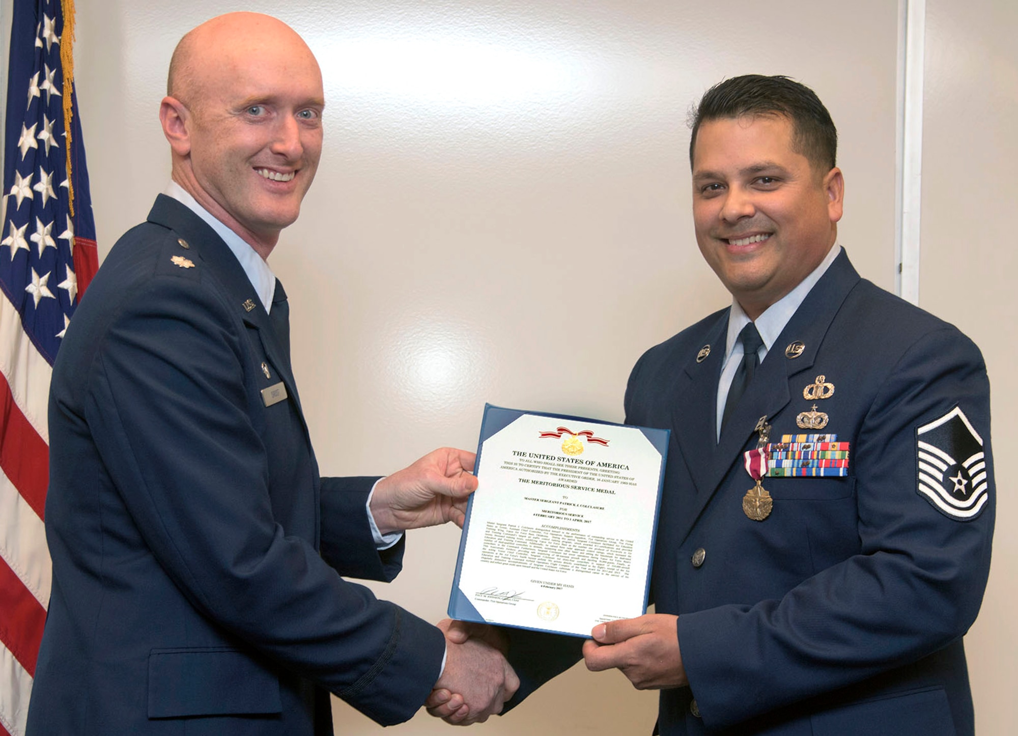 Master Sgt. Patrick Colclasure, right, receives a Meritorious Service Medal from Lt. Col. Michael Drost, the 71st Operations Support Squadron commander, during a retirement ceremony held March 17, at Vance Air Force Base, Oklahoma. (U.S. Air Force photo/ Terry Wasson)