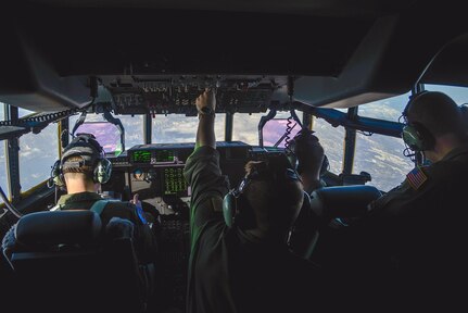 Staff Sgt. Christopher Hofer, 36th Airlift Squadron loadmaster, flips a fuel panel switch during the first Yokota C-130J Super Hercules training sortie over the skies of Japan March 20, 2017. By flipping the switch, the crew members are able to properly balance the fuel tanks.