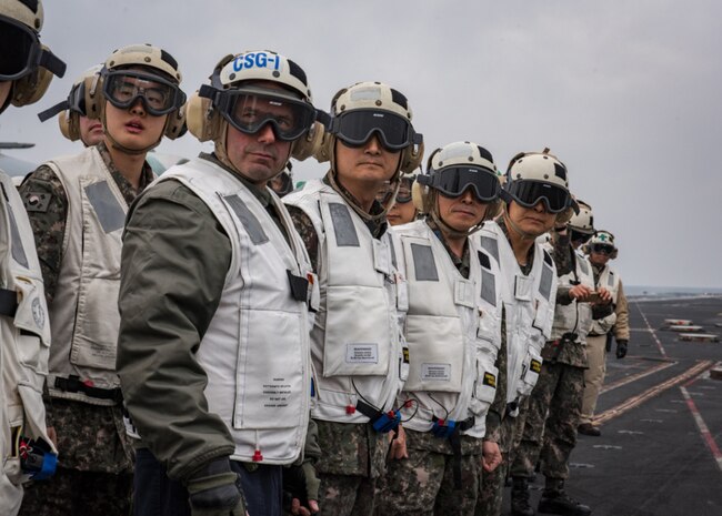 Rear Adm. Jim Kilby, commander, Carrier Strike Group 1, left, Adm. Um, Hyun Seong, Republic of Korea chief of naval operations, left center, Gen. Jeong, Kyeongdoo, chief of staff of the Republic of Korea Air Force, right center, and Gen. Jang, Jun Gyu, chief of staff of the Republic of Korea Army, right, observe flight operations on the aircraft carrier USS Carl Vinson (CVN 70) flight deck, Mar. 20, 2017. The Carl Vinson Carrier Strike Group is on a regularly scheduled Western Pacific deployment as part of the U.S. Pacific Fleet-led initiative to extend the command and control functions of U.S. 3rd Fleet. U.S Navy aircraft carrier strike groups have patrolled the Indo-Asia-Pacific regularly and routinely for more than 70 years. 