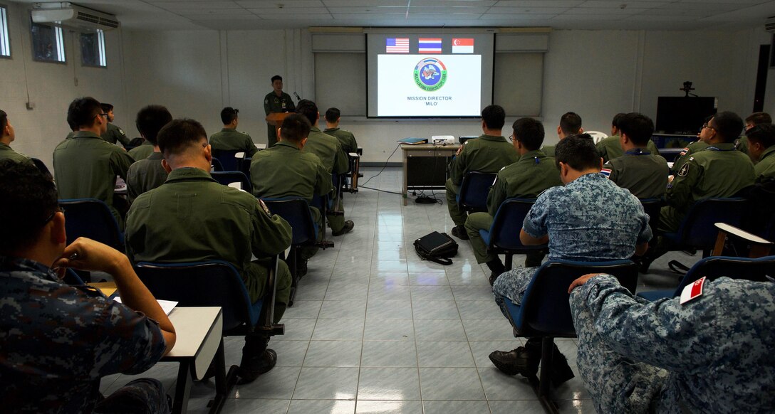 Pilots from the Royal Thai air force (RTAF), Republic of Singapore air force (RSAF), and U.S. Air Force (USAF) listen during a mission briefing for exercise Cope Tiger 2017 at Korat Royal Thai Air Force Base, Thailand, March 21, 2017. Over 1,200 U.S., Thai and Singaporean military members will participate in CT17. The annual multilateral exercise is aimed at improving combined combat readiness and interoperability between the RTAF, RSAF and USAF, while concurrently enhancing the three nations' military relations. (U.S. Air Force photo by Staff Sgt. Kamaile Chan)