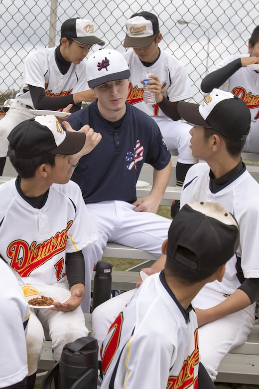 The Okiboys and Okinawa Diamond baseball players talk together March 18 aboard Camp Foster, Okinawa, Japan. After the teams played their first game, the parents of the Okiboys baseball team hosted a potluck for the players, coaching staff and family members of both teams. The Okiboys baseball team has been in existence for 12 years, and invites local teams to come onto military bases and play. 