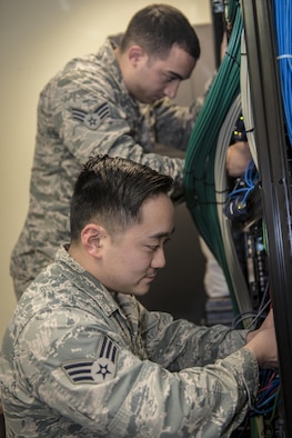 U.S. Air Force Senior Airman Jeffrey Fujita, a knowledge management technician with the 7th Air Force Combined Battle Watch at Osan Air Base, Republic of Korea, bottom, and Senior Airman Eric Roman, a knowledge management technician with the 747th Communications Squadron at Joint Base Pearl Harbor-Hickam, Hawaii, top, troubleshoot network issues for the commander’s staff during Key Resolve 2017 at Osan Air Base, ROK, March 22, 2017. Responsible for the coordination and distribution of information and data, knowledge management specialists play a critical role in every department of the Air Force and are vital to command and control exercises such as Key Resolve. (U.S. Air Force photo by Staff Sgt. Benjamin W. Stratton)