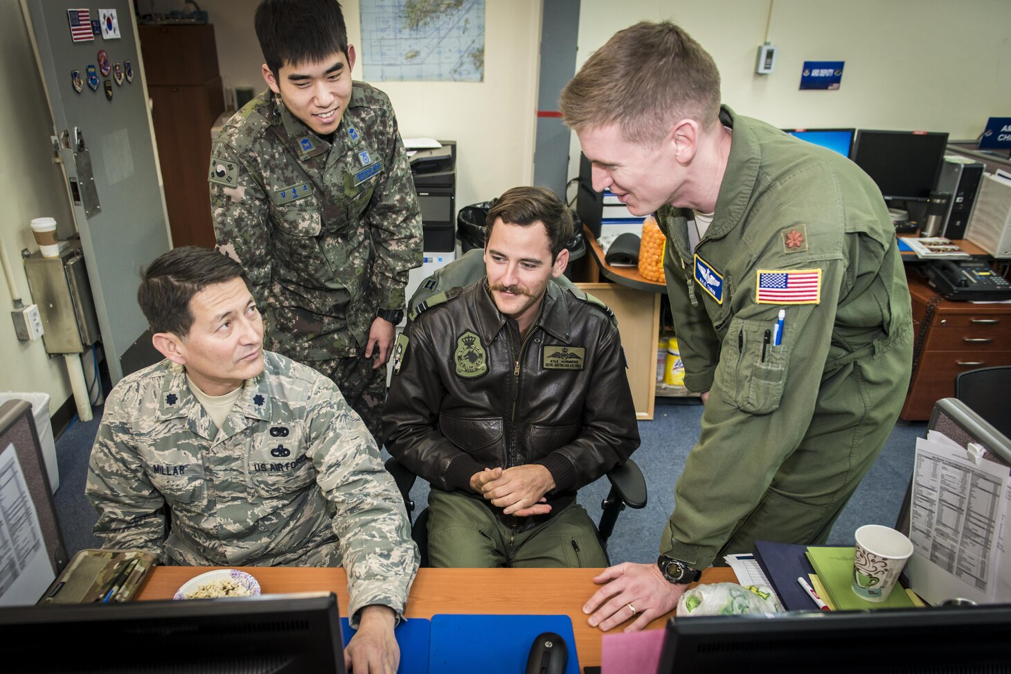 U.S. Air Force Lt. Col. Fredrick Millar, left, talks airlift strategy with Royal Australian Air Force Flt. Lt. Kyle Hornberg, right center, and U.S. Air Force Maj. Kyle Tobin, right, as Republic of Korea Air Force 2nd Lt. Dongjo Kim, left center, takes notes for sharing with ROKAF airlift counterparts in the Korean Air Operations Center’s Air Mobility Division during Key Resolve 2017 at Osan Air Base, Republic of Korea, March 22, 2017. The four work together in the AMD ensuring timely airlift support, communication and execution for all Key Resolve missions. Millar is the assistant director of operations and airlift control team member with the 349th Air Mobility Operations Squadron at Travis Air Force Base, California. Hornberg is the Air Mobility Division Multinational Coordination Center liaison officer with the Air Mobility Control Center at Royal Australian Air Force Base Richmond, Australia, Tobin is with the 621st Air Mobility Squadron at Joint Base McGuire-Dix-Lakehurst, New Jersey, and Kim is an interpreting officer with the Air Component Command’s join plans and coordination division at Osan AB. (U.S. Air Force photo by Staff Sgt. Benjamin W. Stratton)