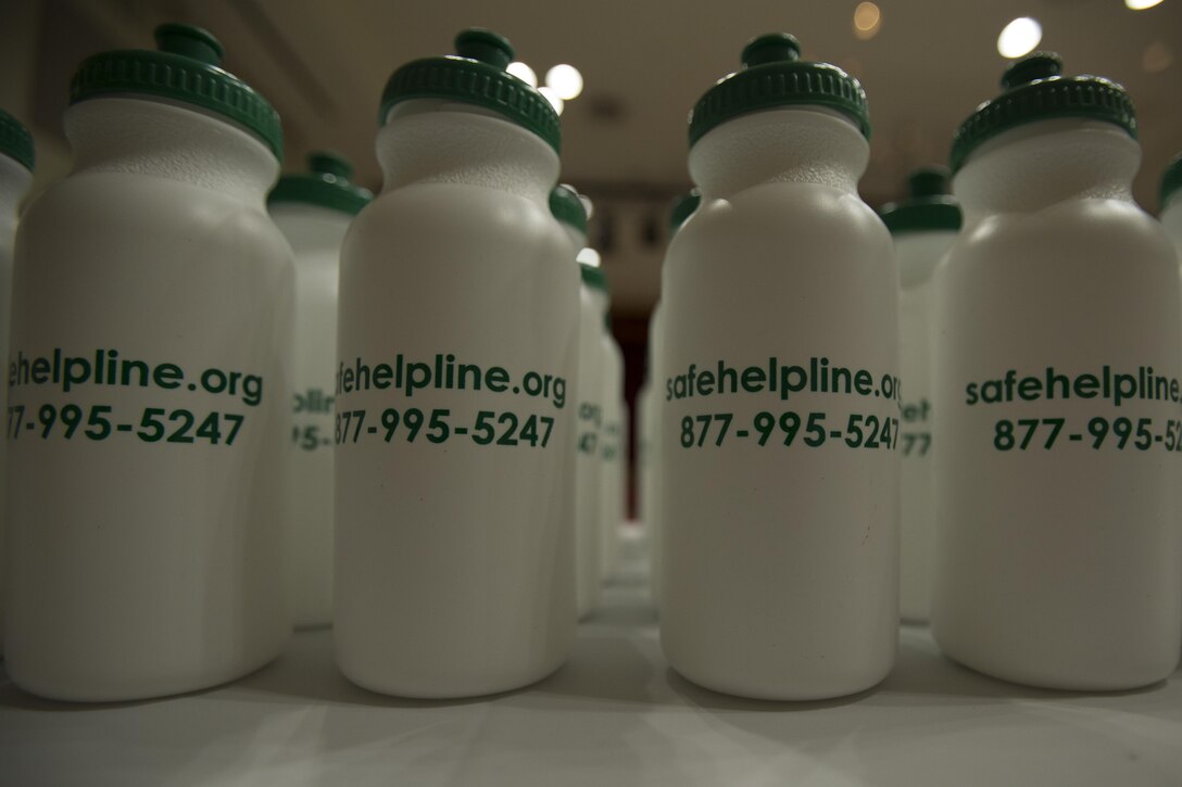Water bottles with the Safe Helpline information sit on a table during a Sexual Assault Prevention Readiness Victim Advocate recognition event, and a Department of Defense Safe Helpline presentation March 14 aboard Camp Foster, Okinawa, Japan. If there is a need to talk, the number to call is 877-995-5274, it is the same worldwide through the Defense Switched Network. If a call isn’t preferred, there is one-on-one help at SafeHelpline.org, this website also provides information about recovering from and reporting sexual assault. If the preference is to speak to others who have survived similar experiences, there is an online chatroom at SafeHelpRoom.org.