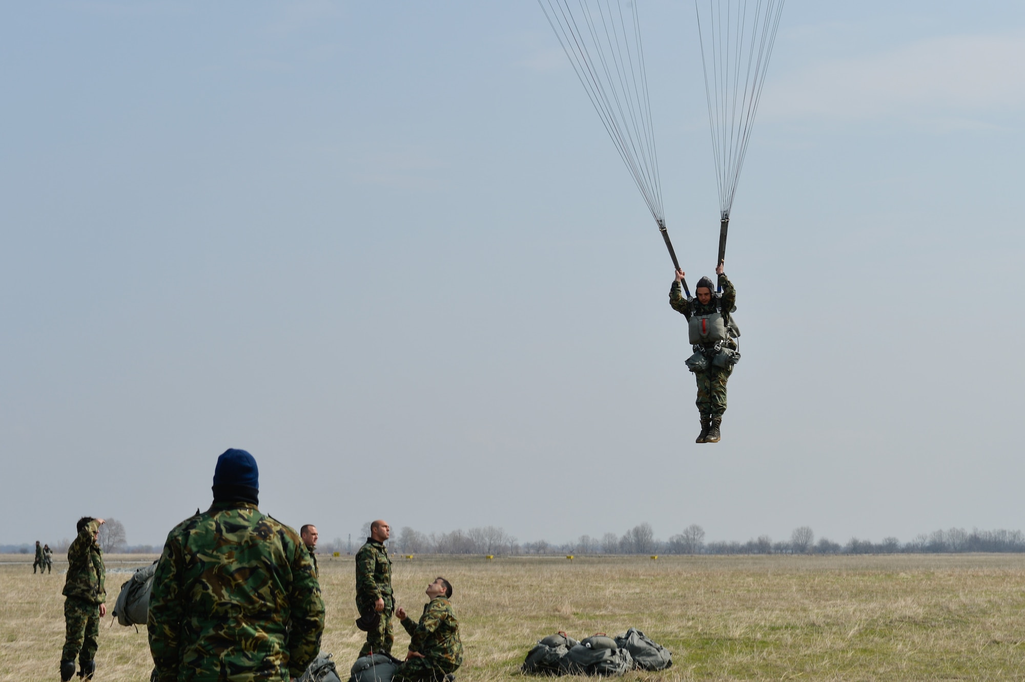 A Bulgarian paratrooper descends from a C-130J Super Hercules during Exercise Thracian Spring 17 at Plovdiv Regional Airport, Bulgaria, March 15, 2017. Airmen from the 37th Airlift Squadron, 435th Contingency Response Group, and 86th Airlift Wing, Ramstein Air Base, Germany, partnered with the Bulgarian military for the two-week exercise. The U.S. Air Force’s forward presence in Europe allows Airmen to work hand-in-hand with Allies to develop and improve ready air forces that are capable of maintaining regional security.  (U.S. Air Force photo by Staff Sgt. Nesha Humes)