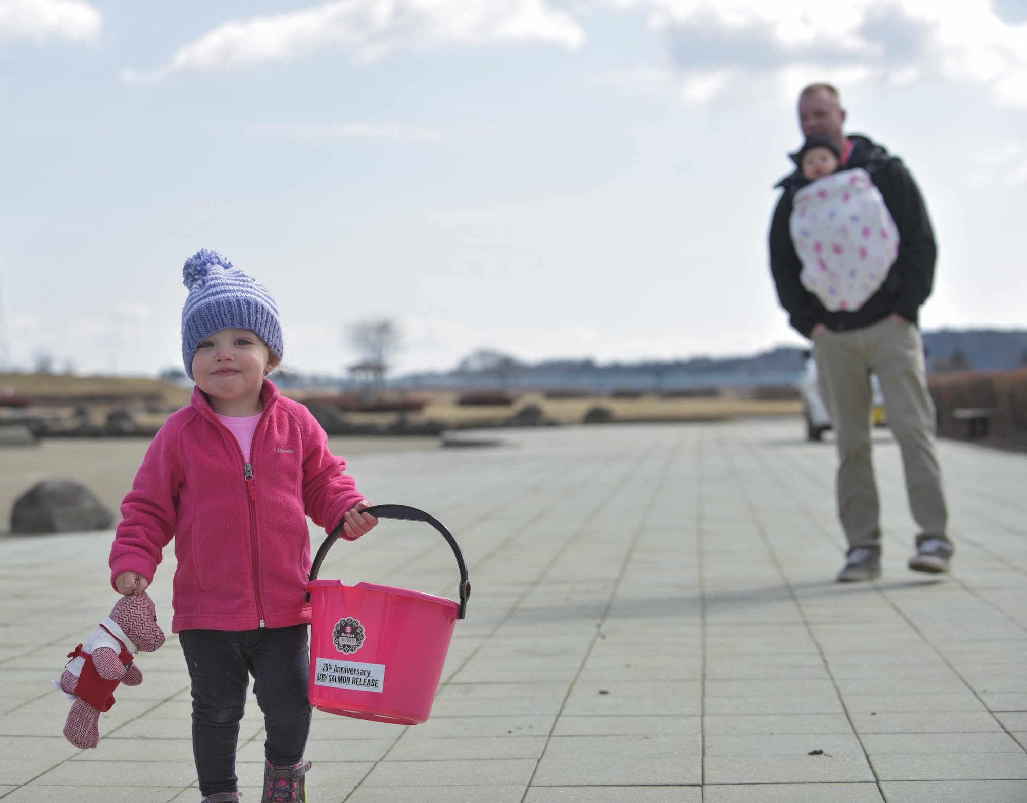 Addelyn, daughter of U.S. Air Force Tech. Sgt. Shannon Hutto, a 35th Security Forces Squadron swings flight chief, walks with a bucket during the 20th Annual Baby Salmon Release at Oirase Town, Japan, March 18, 2017.  The event provided a bonding experience for the Japanese and Americans. (U.S. Air Force photo by Staff Sgt. Melanie A. Hutto)
