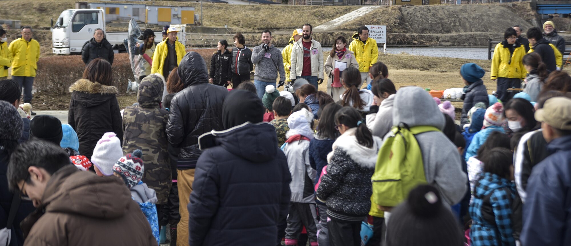 U.S. civilian contractor Zakary Payne, the 35th Civil Engineer Squadron deputy base civil engineer, provides opening remarks prior to the start of the 20th Annual Baby Salmon Release, Oirase Town, Japan, March 18 2017. Every year, Misawa Air Base community members partner with local Japanese citizens to release more than 400,000 young fish into the Oirase River to grow, breed and return for the annual Rokkasho Salmon Festival in the fall. (U.S. Air Force photo by Staff Sgt. Melanie Hutto)