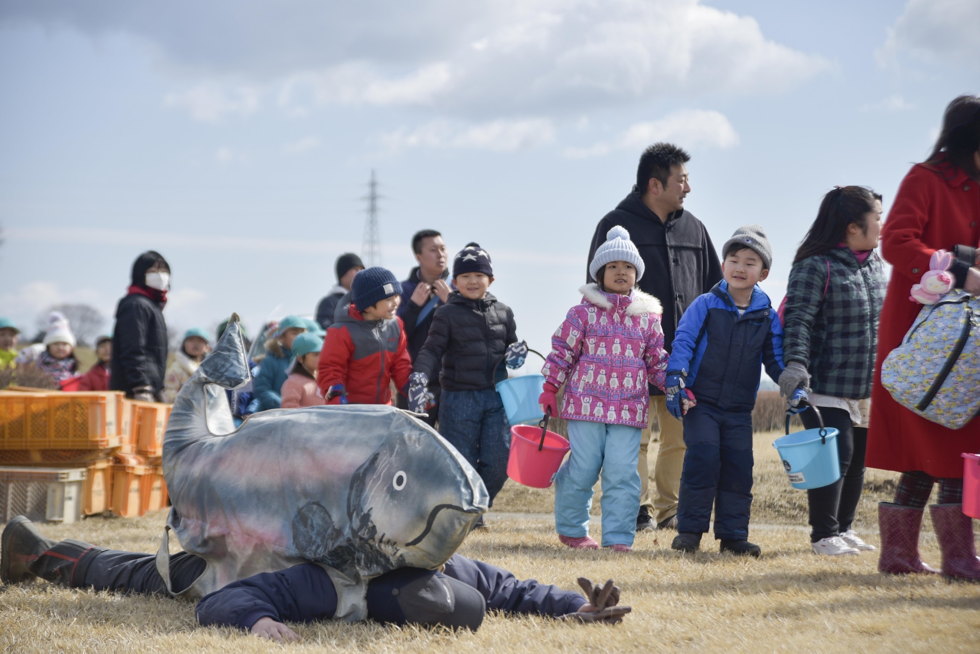 Children walk toward a truck housing more than 400,000 baby salmon during the 20th Annual Baby Salmon Release at Oirase Town, Japan, March 18, 2017. The event embodies the Japanese culture and their rich history associated with connection to the Earth. American attendance strengthens the partnership between the two nations. (U.S. Air Force photo by Staff Sgt. Melanie A. Hutto)