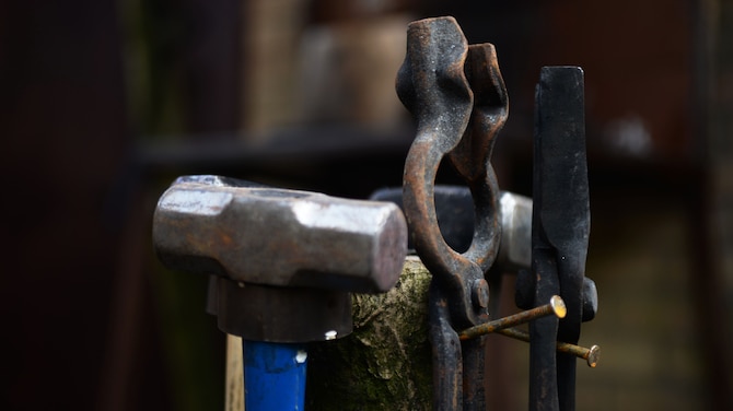 Blacksmithing tools hang from a wooden post Feb. 11, 2017, in Suffolk, England. Blacksmithing began during the “Iron Age” and over the years the tools evolved to better assist the handler. (U.S. Air Force photo by Airman 1st Class Tenley Long)