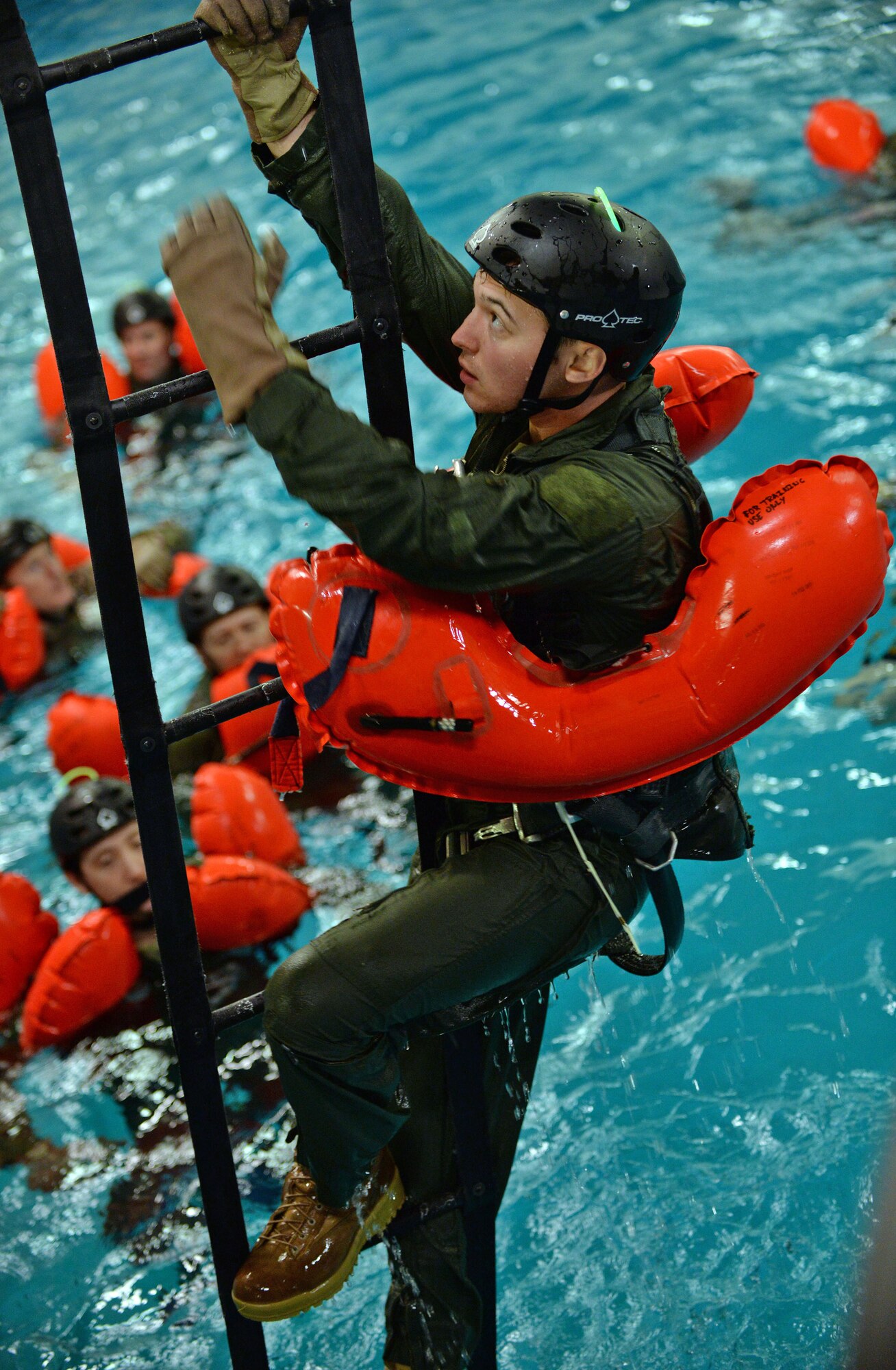 A U.S. Air Force Air Commando from the 352nd Special Operation Wing, climbs a ladder during Survival, Evasion, Resistance and Escape Water Survival Training March 10, 2017, at Lowestoft College, Maritime and Offshore Facilities, England. Climbing the ladder simulated what it would be like to climb into an aircraft if stuck in the middle of the ocean. (U.S. Air Force photo by Senior Airman Christine Halan)