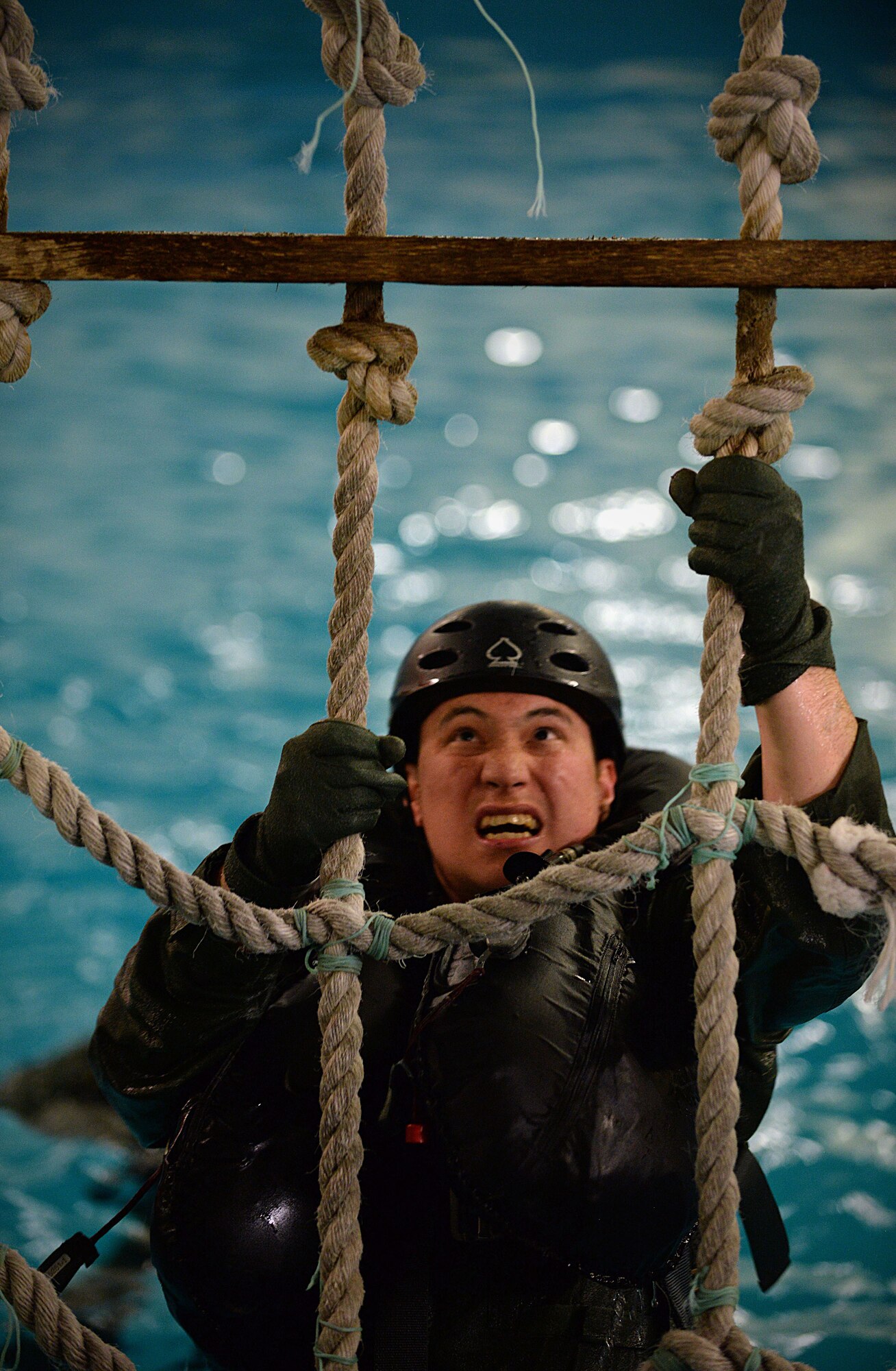 A U.S. Air Force Air Commando from the 352nd Special Operation Wing, climbs a cargo net ladder during Survival, Evasion, Resistance and Escape Water Survival Training March 10, 2017, at Lowestoft College, Maritime and Offshore Facilities, England. Climbing the ladder simulated what it would be like to climb into an aircraft if stuck in the middle of the ocean. (U.S. Air Force photo by Senior Airman Christine Halan)