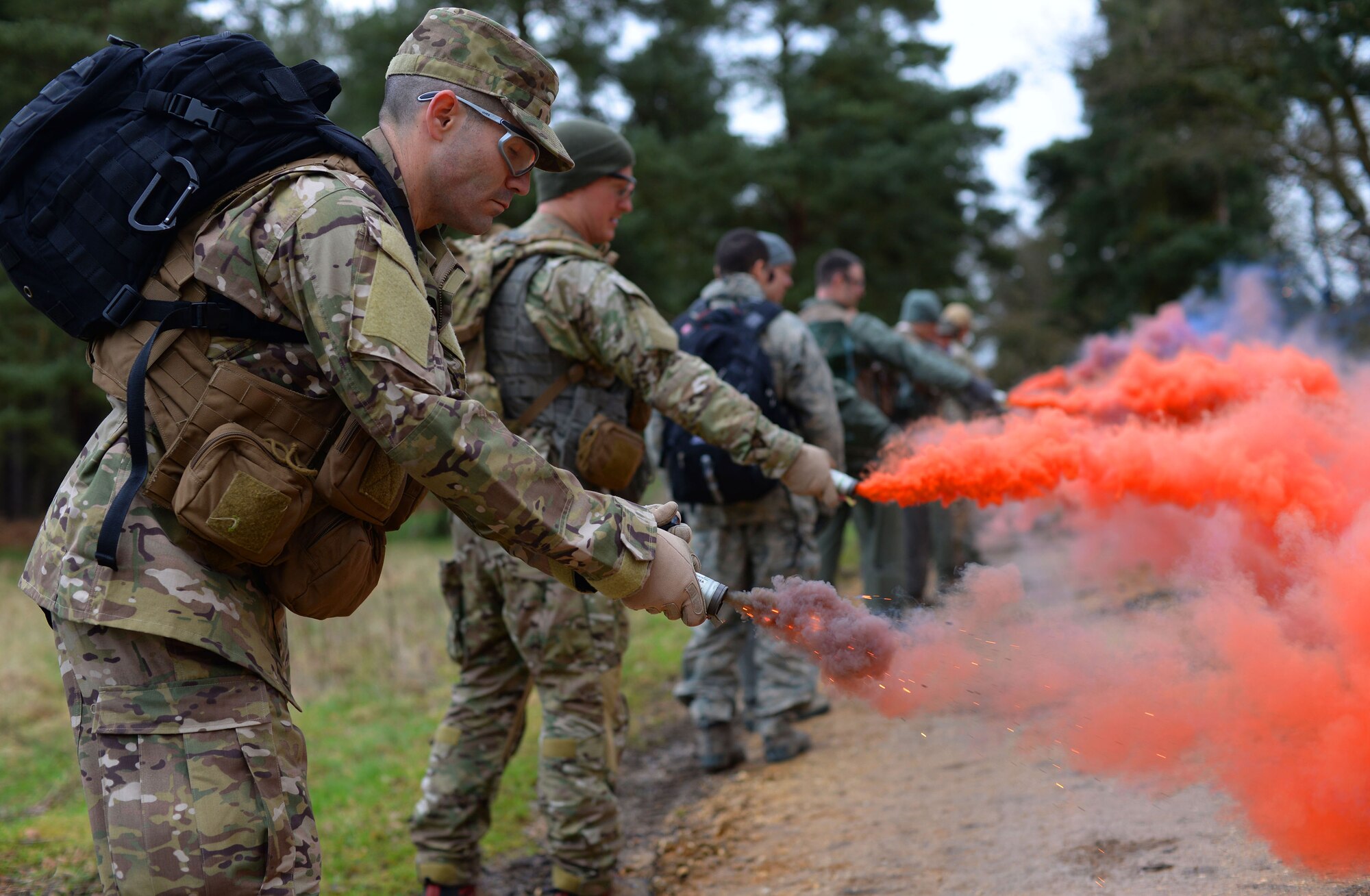 U.S. Air Force Airmen from the 100th Air Refueling Wing, and 352nd Special Operations Wing from RAF Mildenhall, England, and 48th Fighter Wing from RAF Lakenheath, England, test smoke bombs March 8, 2017, at the Stanford Training Area, England. Every three years the Airmen must undergo survival, evasion, resistance and escape training to maintain proficiency. (U.S. Air Force photo by Senior Airman Christine Halan)