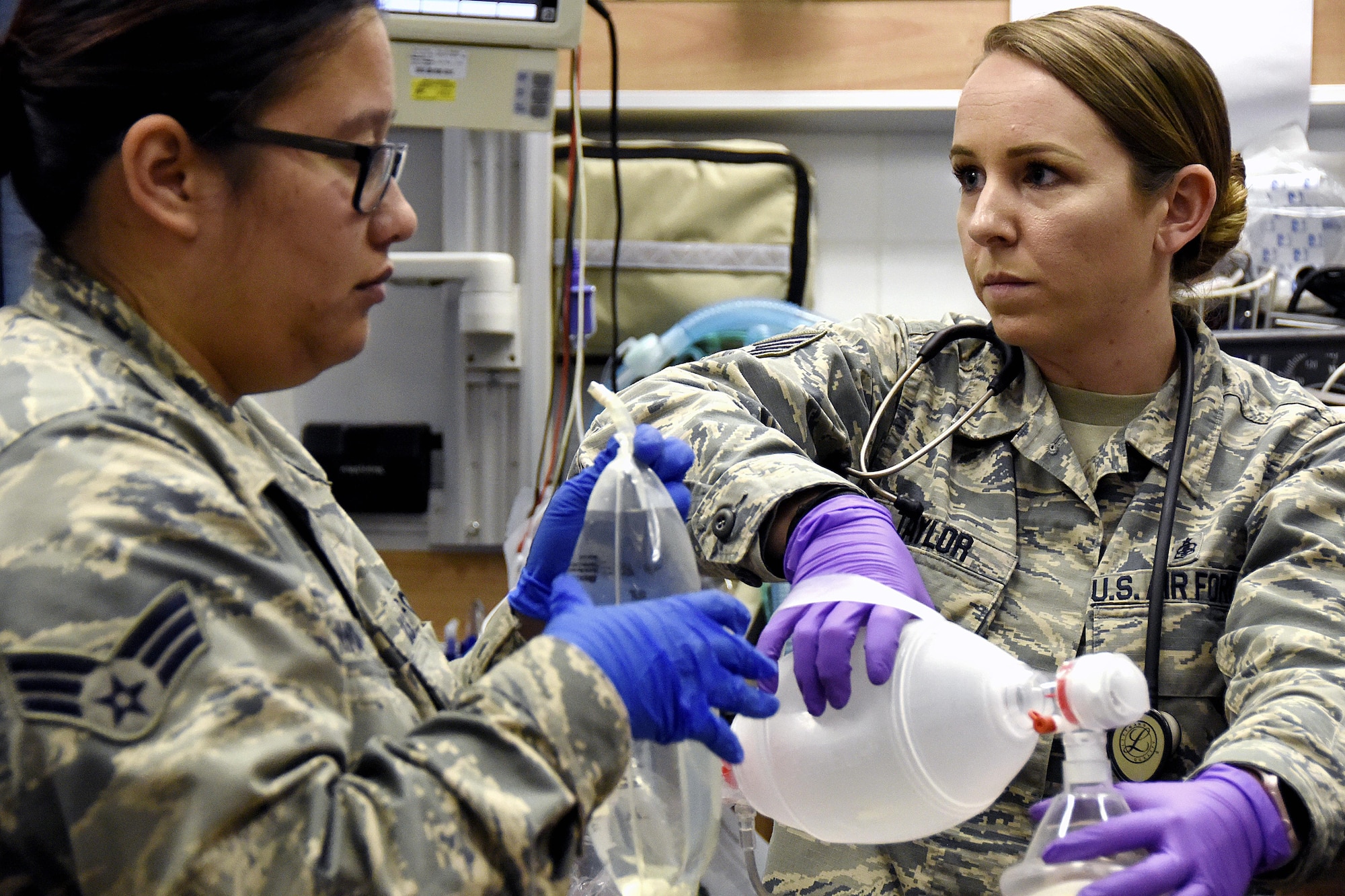 U.S. Air Force Staff Sgt. Samantha Taylor, an aerospace medical technician, right, squeezes a bag mask ventilator as U.S. Air Force Senior Airman Shaina Kelnhoser, a flight medicine technician, both with the with the 379th Expeditionary Medical Group holds an IV bag during a Lifeflight medical trauma exercise at Al Udeid Air Base, Qatar, March 22, 2017. The exercise was held to practice the process of extracting a patient from a vehicle accident, followed by stabilizing and evacuating the patient via aircraft. (U.S. Air Force photo by Senior Airman Cynthia A. Innocenti)