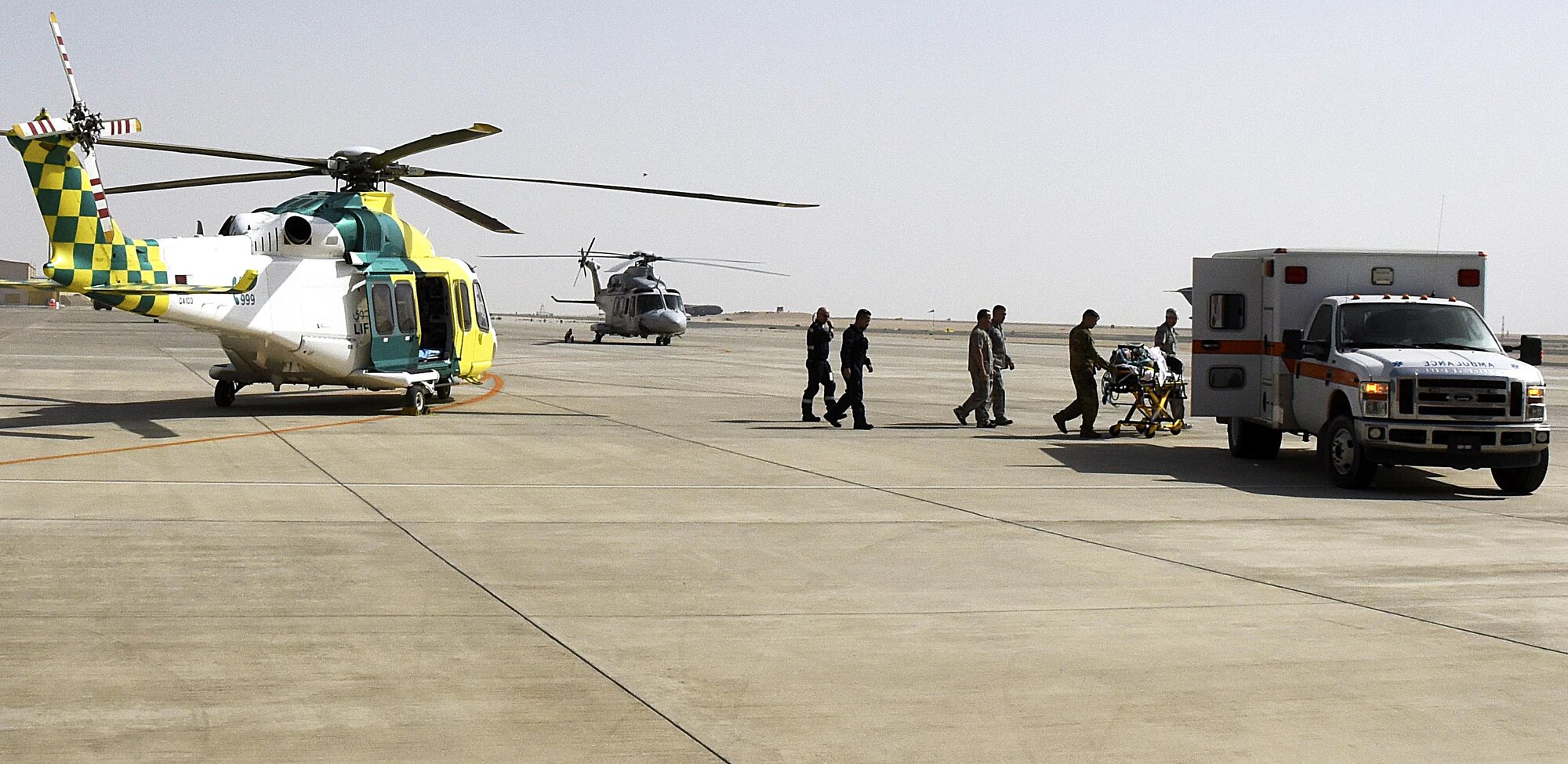 U.S. Air Force Airmen with the 379th Expeditionary Medical Group carry their medical equipment back to an ambulance after a Lifeflight medical trauma exercise Al Udeid Air Base, Qatar, March 21, 2017. The exercise was held to practice the process of extracting a patient from a vehicle accident, followed by stabilizing and evacuating the patient via aircraft. (U.S. Air Force photo by Senior Airman Cynthia A. Innocenti)