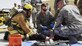U.S. Air Force Airmen with the 379th Expeditionary Medical Group and firefighters with the 379th Expeditionary Civil Engineer Squadron lift a role player acting as a trauma patient at Al Udeid Air Base, Qatar, March 21, 2017. Scenarios like these are enacted to help first responders train and maintain their skillsets. (U.S. Air Force photo by Senior Airman Cynthia A. Innocenti)