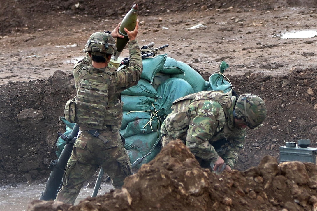 A soldier loads a round during a mission supporting the Iraqi army's 9th Division near Tarab, Iraq, March 14, 2017. The soldier is a mortarman assigned to the 82nd Airborne Division’s 2nd Brigade Combat Team, Combined Joint Task Force Operation Inherent Resolve. The soldiers provide mission advice and assistance, planning, intelligence collection and analysis, force protection, and precision fires to achieve the military defeat of ISIS. Army photo by Sgt. Thomas Carwell