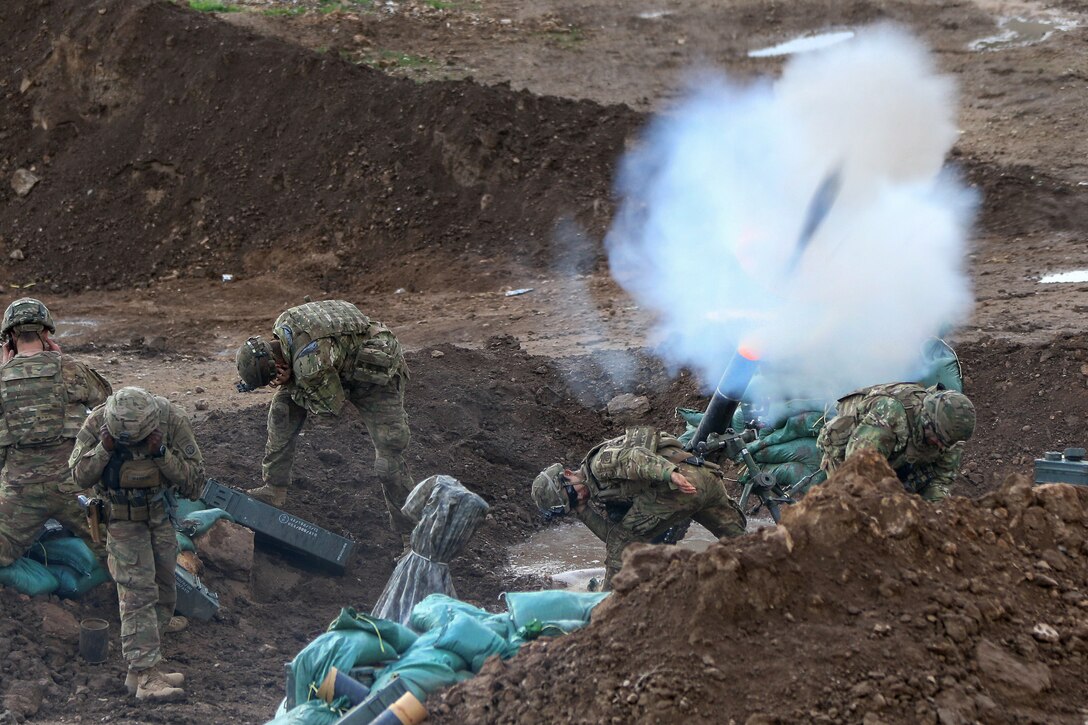 Soldiers fire mortar rounds during a fire mission supporting the Iraqi army's 9th Division near Tarab, Iraq, March 14, 2017. Army photo by Sgt. Thomas Carwell