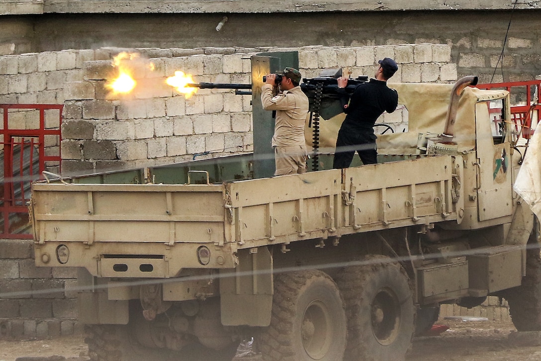 Iraqi soldiers fire a heavy machine gun at Islamic State of Iraq and Syria fighting positions near Tarab, Iraq, March 17, 2017. The soldiers are assigned to the 9th Division. Army photo by Staff Sgt. Jason Hull